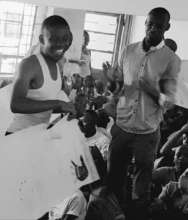 Kayitare holding artwork with teacher Bashir