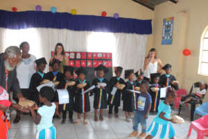 Children receiving gifts from community elder