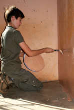 A volunteer repainting one of our NCP's