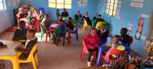 NCP children sitting and doing class work