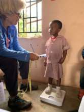 Peggy taking BMI of the children at one of our NCP
