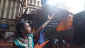 A girl showing the damaged roof