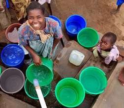 Siyileni Mandala collecting water with her son