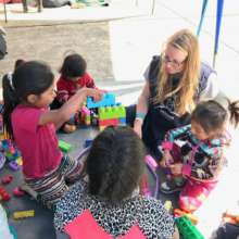Volunteer Anya playing Lego with the children