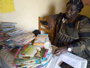 Rose Mugenyi with books provided by Book Buddy
