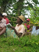 Odette reading the CPALI training manual that Mamy wrote