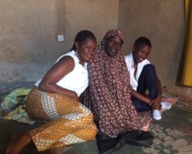 Kellen (left) visits a new student's family