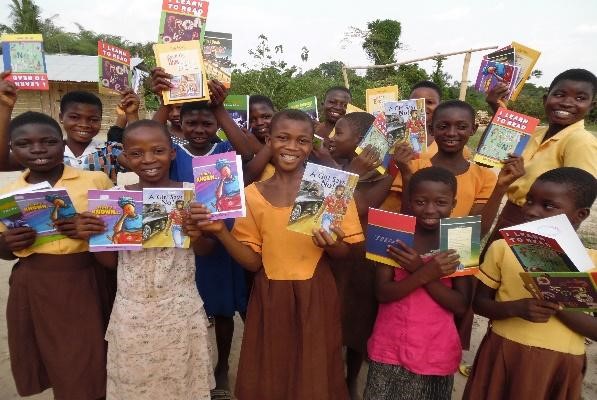 group of teen girls poses happily with their new books