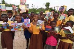 Smiling Timeabu teen girls posing with their books