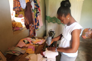 Munaya sewing some sanitary pads