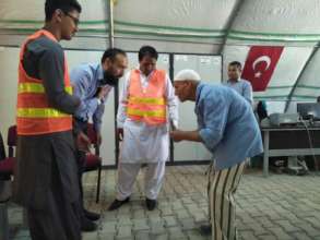 CHCS team greeting and helping a senior refugee