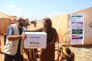 A Syrian widow receiving relief goods