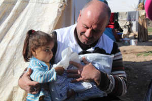 A Syrian Child receiving gifts