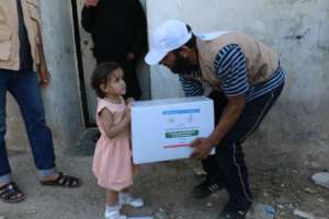 An orphan receiving relief packet.