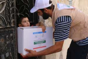 Syrian child receiving relief goods.