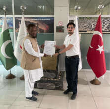 Cash donation being handed over to the Turkish RC
