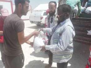 Syrian refugees receiving relief goods