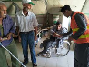 Handing over cash to the disabled Syrian Refugees