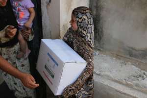Small Girl receiving Packet of Relief Goods