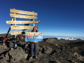 Sara Safari at the summit of Mt. Kilimanjaro