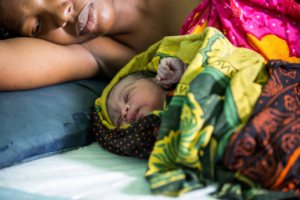 A mother cradles her newborn after a safe birth