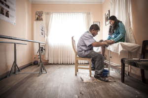 Patient being measured for prosthetic leg