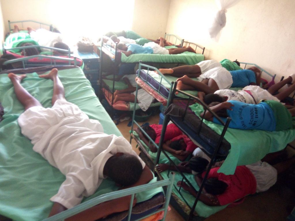Sleeping two per bed the girls crowd into the dorm