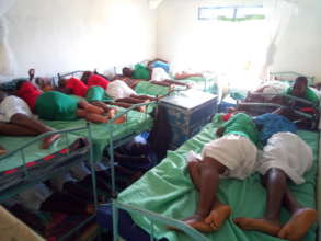 Girls demonstrate how they sleep 2 per bed.