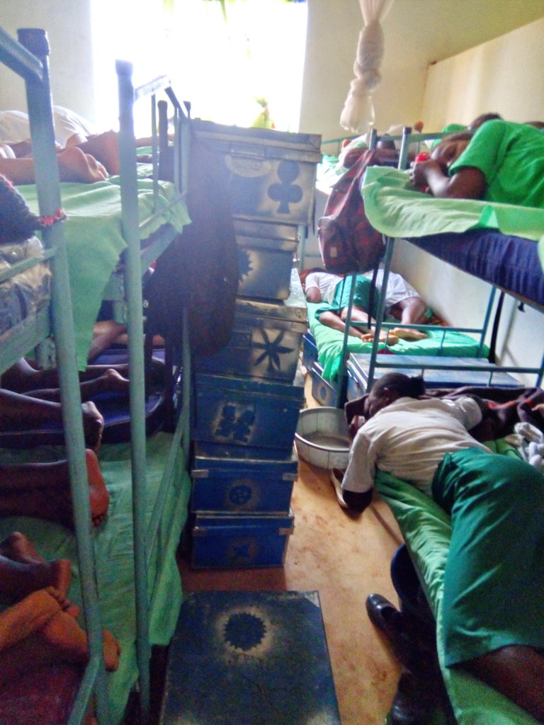 The girl's belongings are kept in boxes piled high