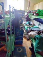 The girl's belongings are kept in boxes piled high