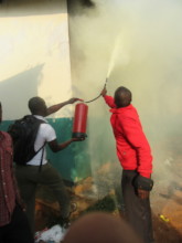 Kenya Keys' staff Alex and Stephen douse the fire.