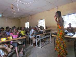 Martine addressing students in an MHM training