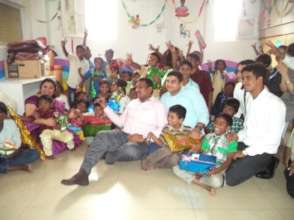 Volunteers giving gifts during Diwali