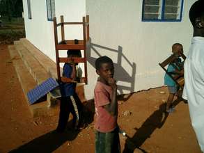 School children helping carry the furniture