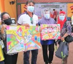Teachers and students proudly display posters