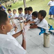 Girls and boys handwash together at Timbangan Elem