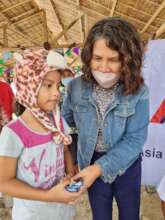 Distributing vitamins and candy to flood victims
