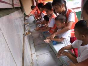 Students wash hands before school lunch