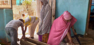 Mrs. Mohamed cutting to size a piece of wood