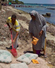 The team mixing sand, ballast and cement.