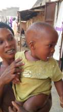 A worried mother brings her sick baby