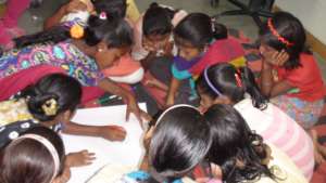 Girls engaged in their group work for the project
