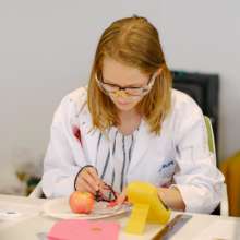 Testing voltage during our fruit battery workshop