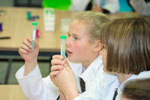 Girls learning how to extract DNA in Surrey, UK