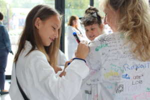 Greenlight girl signs the Founder's labcoat