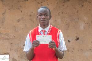 Student holding a tuition fee payment cheque