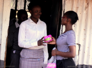 A happy girl receiving sanitary towels .