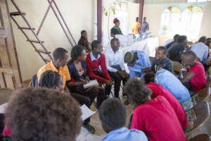 Jane (The one holding a pen) leading a group