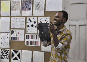 Nanjibhai, a weaver, presents basic design work