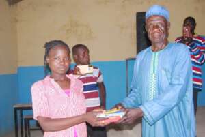 Blessing receiving books during her graduation